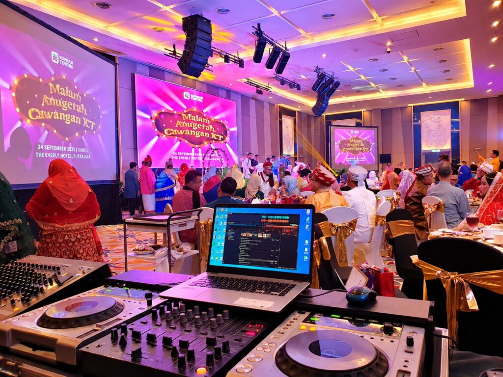Annual dinner with colourful stage lighting, large screens and DJ equipment